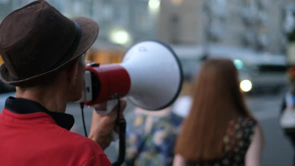 Speaking with Bullhorns Protesters Marching on City Streets in Peaceful Picket