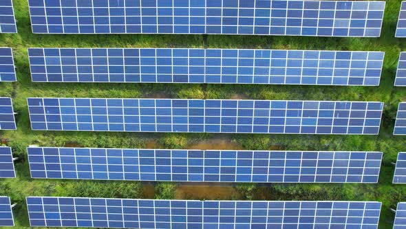 Drone fly over solar farm, renewable energy from solar.