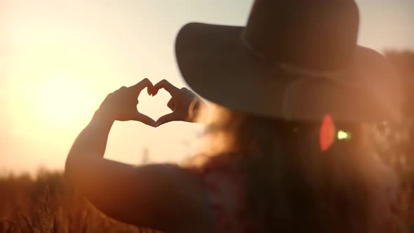 Heart Shape From Fingers.Woman Making Heart Shape With Hands.Woman In Hat Enjoing Sun.Love Sign