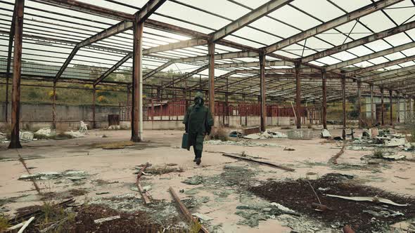 Man with Gas Mask Walks in an Abandoned Place