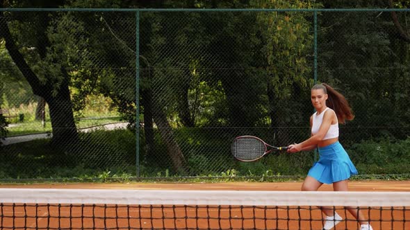 A woman plays tennis with funny fails in slow motion