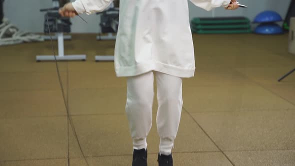 Portrait of a Muslim Woman Training on a Rope in the Gym a Woman in a Sports Hijab