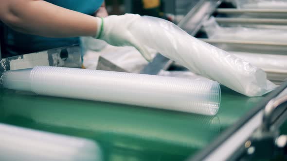 Plant Worker Is Packing Batches of Plastic Cups