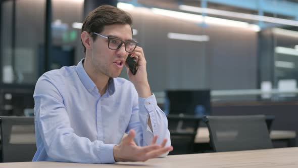 Angry Young Man Talking on Phone