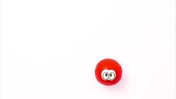 A Funny Bouncing Red Ball with Eyes on a White Background