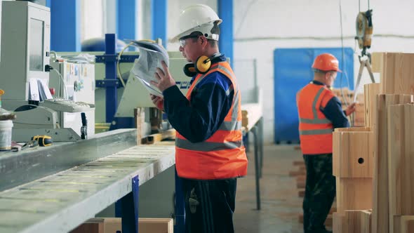 Male Technicians Are Operating in a Woodworking Factory