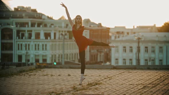 Young Woman Ballerina Training on the Roof