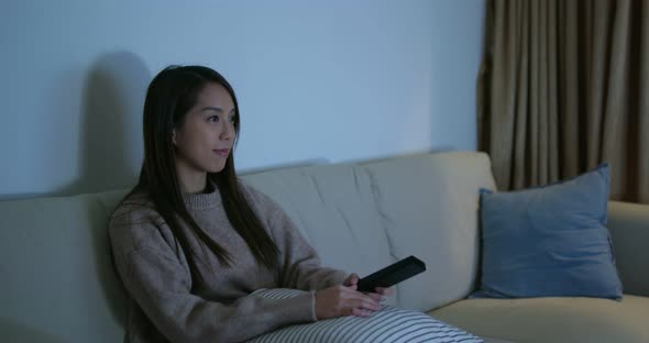 Woman watch tv at home in the evening