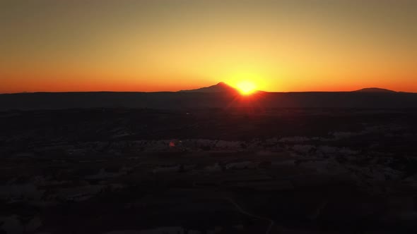 Spectacular Sunset Over Mountain Ridge in Cappadocia Turkey Filmed By Drone at Warm Summer Evening