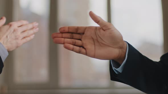 Closeup Funny Male Greeting Gesture of Partnership Two Man African and Caucasian Business Colleagues