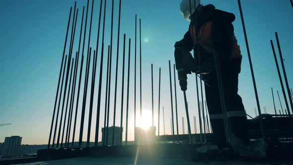 A Worker Is Using a Pneumatic Hammer To Crush Cement