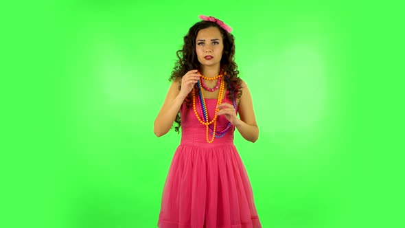 Charming Girl Looks Around, Whispers the Secret and Making a Hush Gesture. Green Screen at Studio