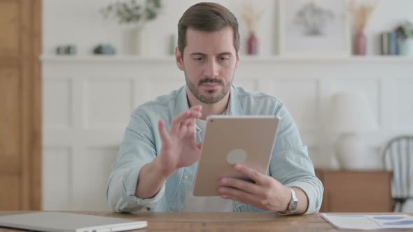 Young Man Using Tablet While Sitting in Office