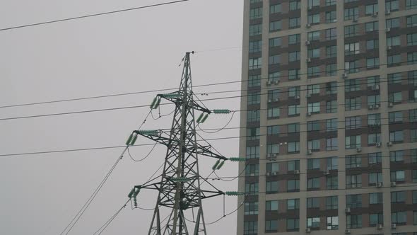 Power Lines on the Background of City Buildings