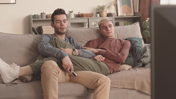 Two Young Men Resting and Watching TV