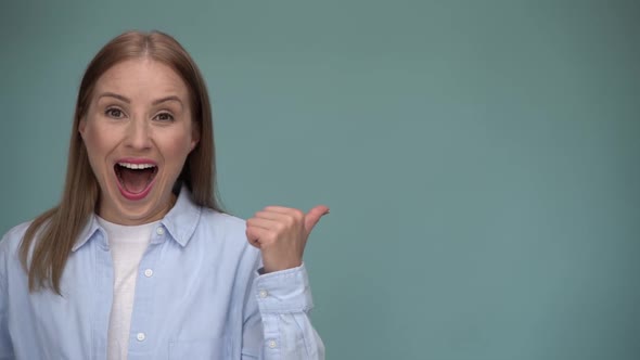 Wow look, advertise here. Portrait of amazed cute woman pointing to empty place on background