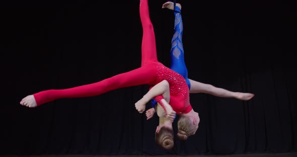 Girls in Colorful Costumes Doing Aerial Gymnastics Upside Down Flexible