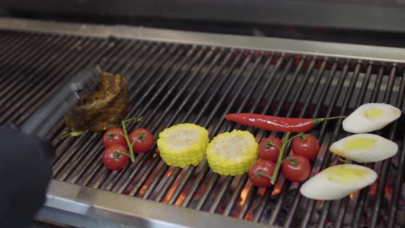 Unrecognized Chef Cooking Vegetable on the Grill in the Restaurant Kitchen