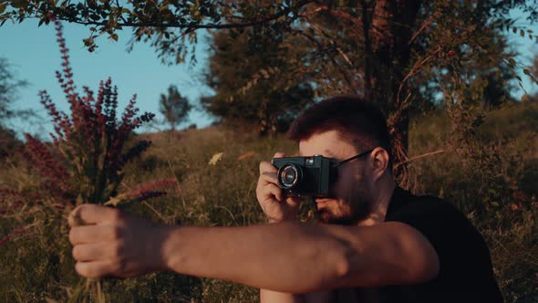 Charismatic Young Man Sits Grass Bouquet Wildflowers His Hand Takes Pictures Retro Camera Magazine