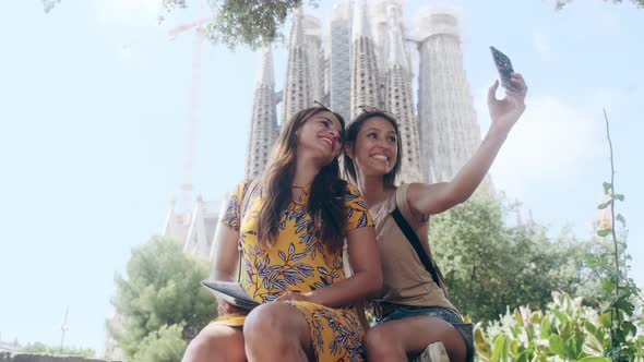 Female tourists taking a selfie at Sagrada Familia, Barcelona, Spain