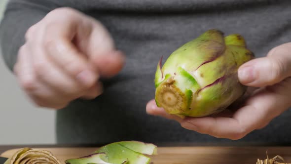 Woman Cleaning Artichokes