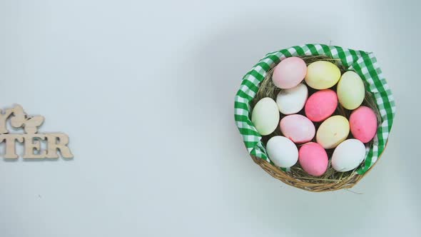 Woman Hand Putting Happy Easter Decoration Near Basket Painted Eggs, Holiday