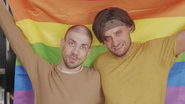 Gay Men with Rainbow Flag Posing for Camera