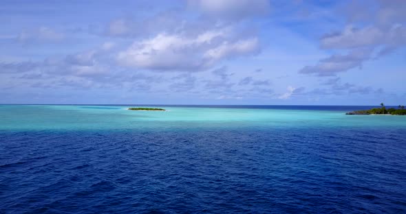 Natural flying abstract view of a white sand paradise beach and aqua blue water background 