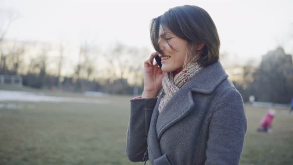 Business Woman Walking and Talking on the Phone