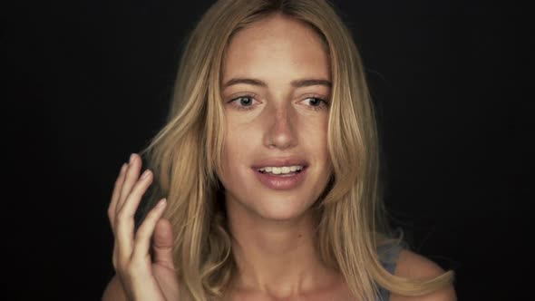 Woman looking down in thought and then raising hands and smiling in comprehension