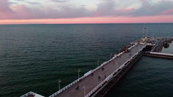 Cinematic pier in the sunset from a bird's eye view. Filming at sunset in Sopot.