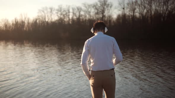 Man Listening To Music In Headphone. Businessman Joyful Walking And Listening Music On Headphone