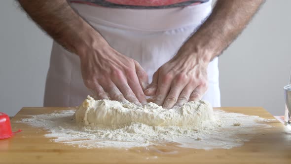 Man's hand preparing pizza dough