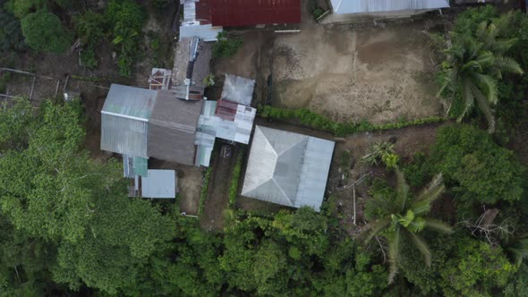 Aerial top down view of a large lodge next to a tropical river