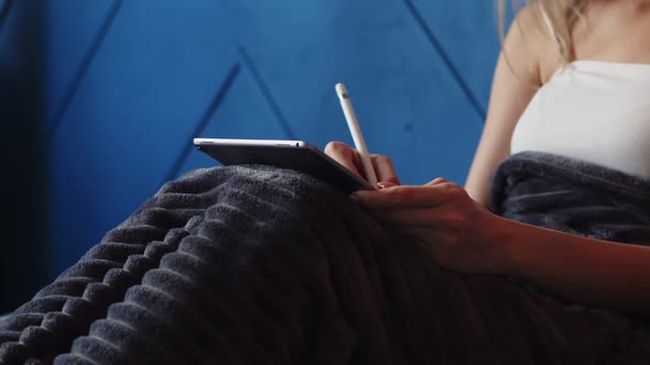 Closeup of Womans Hands Drawing on Graphic Tablet Lying Bed in Her Room with Stylus