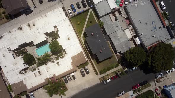 Top down shot of villa with swimming pool and a lot of cars parked outside. University Heights, San