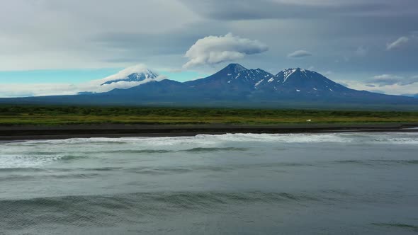 Beach with Black Sand and Volcano