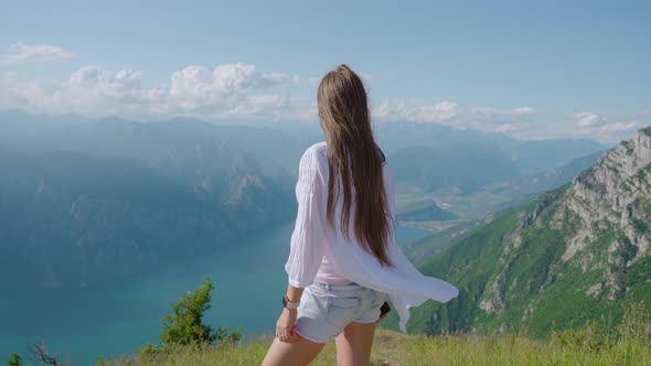 Girl Looks at the Panorama of Lake Garda From the Mountains