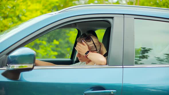 Sick Woman With Headache Sitting On Car.Depressed Tired Stressed Girl.Dissapointed Stressed Driver