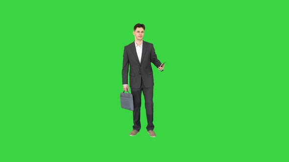 Young Businessman Taking Selfie with His Phone on a Green Screen, Chroma Key