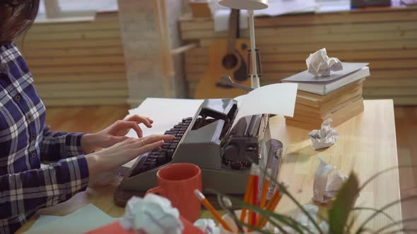 Close Up of Woman Hand Typing on an Old Typewriter