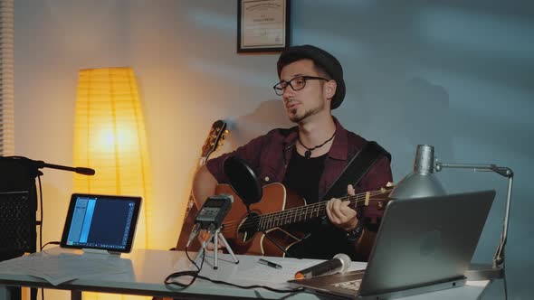 Handsome Young Musician Recording His New Track in Home Studio