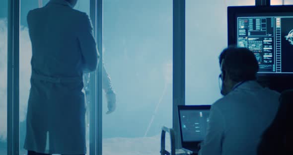 Astronaut and Scientists Testing Spacesuit Mobility alt