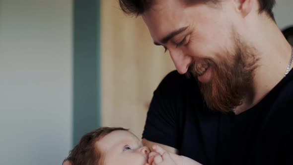 True Face Emotions of Happy Bearded Father with His Little Infant