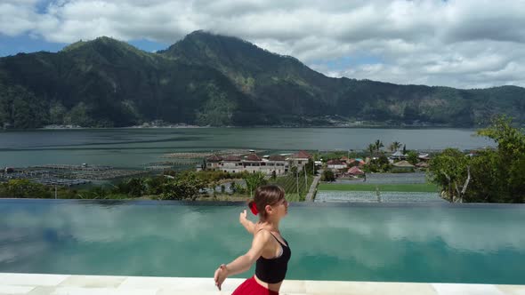 Woman Doing Yoga in Front of Pool Lake and Volcano