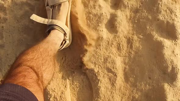 Closeup Caucasian man's with dusty feet walking slow motion with Sandals On Sandy desert or Beach, F