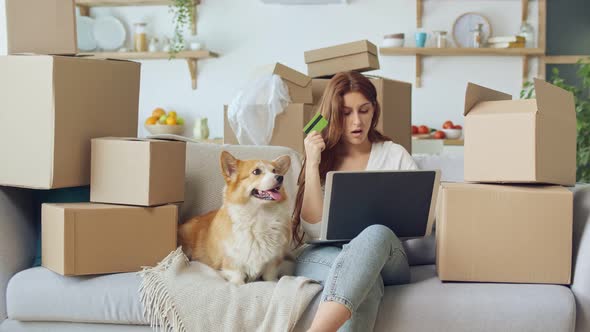 A Woman Uses a Laptop For Online Shopping at Home. Purchase Confirmation By the Internet.