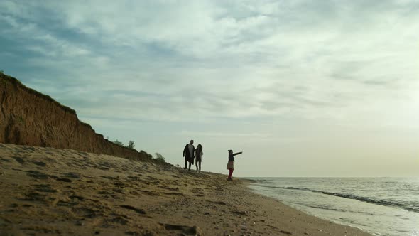 Parents Child Enjoy Sea Waves on Sand Beach