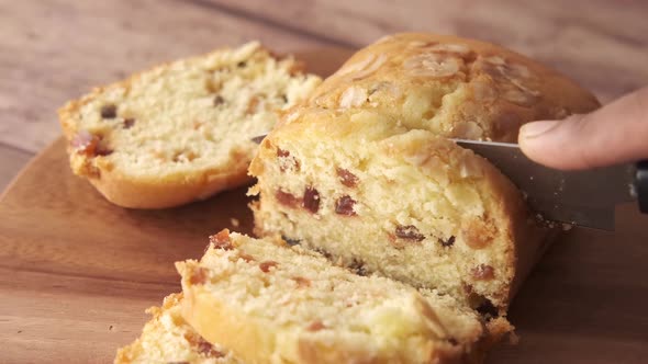 Cutting Bakery Fruit Cake on Chopping Board