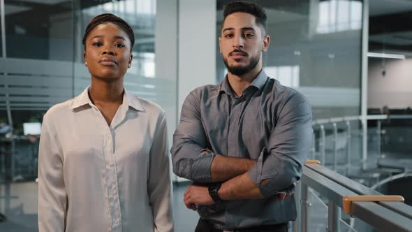 Couple of Two Serious Multiracial Partners Indoors in Office Corporate Company